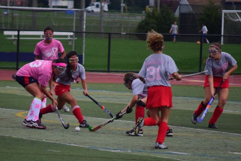 Freshman and first year varsity starter, Julia Patrone, dribbles the ball down the field during their annual pink game.