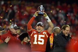 Super Bowl MVP Patrick Mahomes hoisting the Lamar Hunt Trophy.