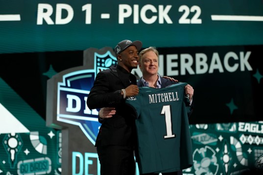 Photo courtesy of Gregory Shamus/Getty Images.
Quinyon Mitchell holds up his new jersey on draft night.